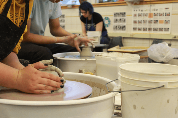 An Edmonds-Woodway High School student works some clay on a potter's wheel.